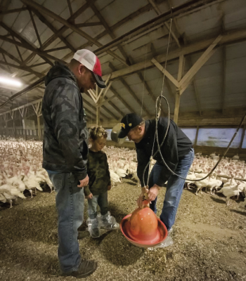 Declan Muehler, 5, enjoys "helping" Grandpa Dave Muehler and his dad, Matt, with farm chores. Dave hopes Declan will be the fourth generation to raise turkeys on the family farm.