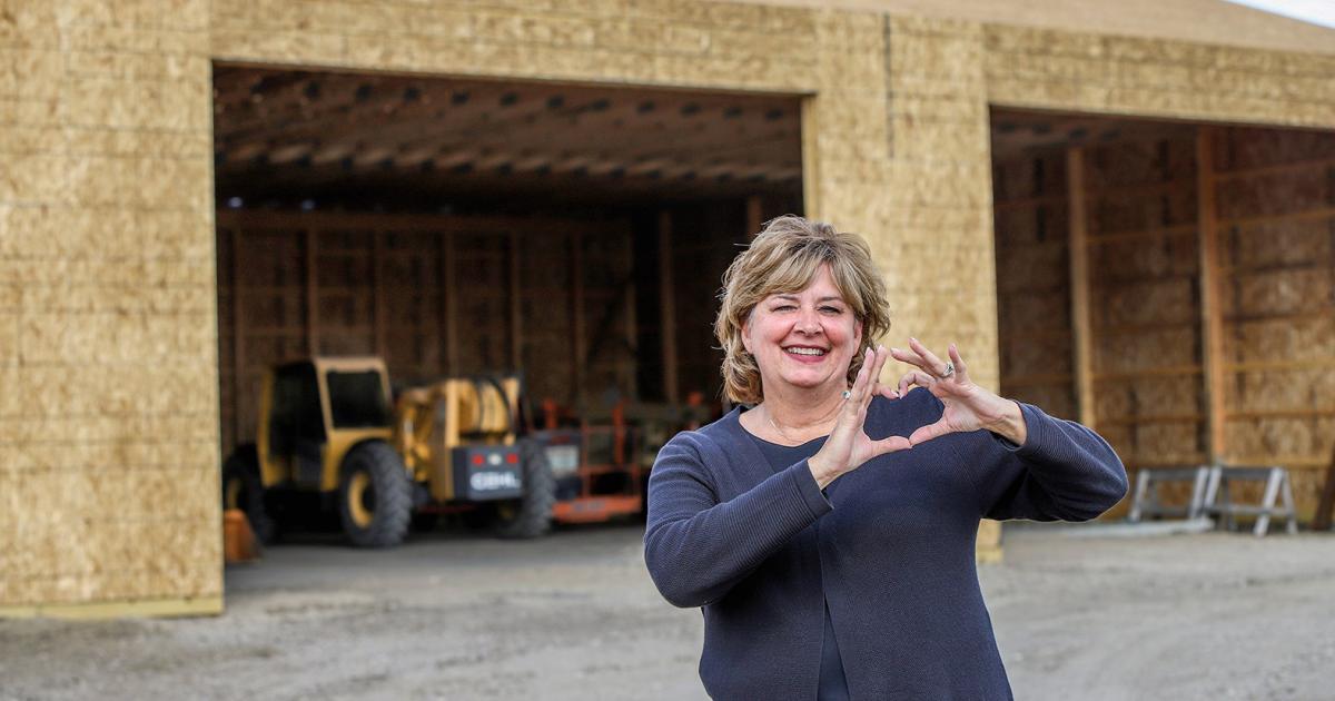Cathy Klocke stands in front of a pole barn being built to replace the one she and her husband, David, lost to a fire last year. Klocke shares the love for the first responders who saved her "shome" (a home and shop combined into one living quarters) located near the pole barn.