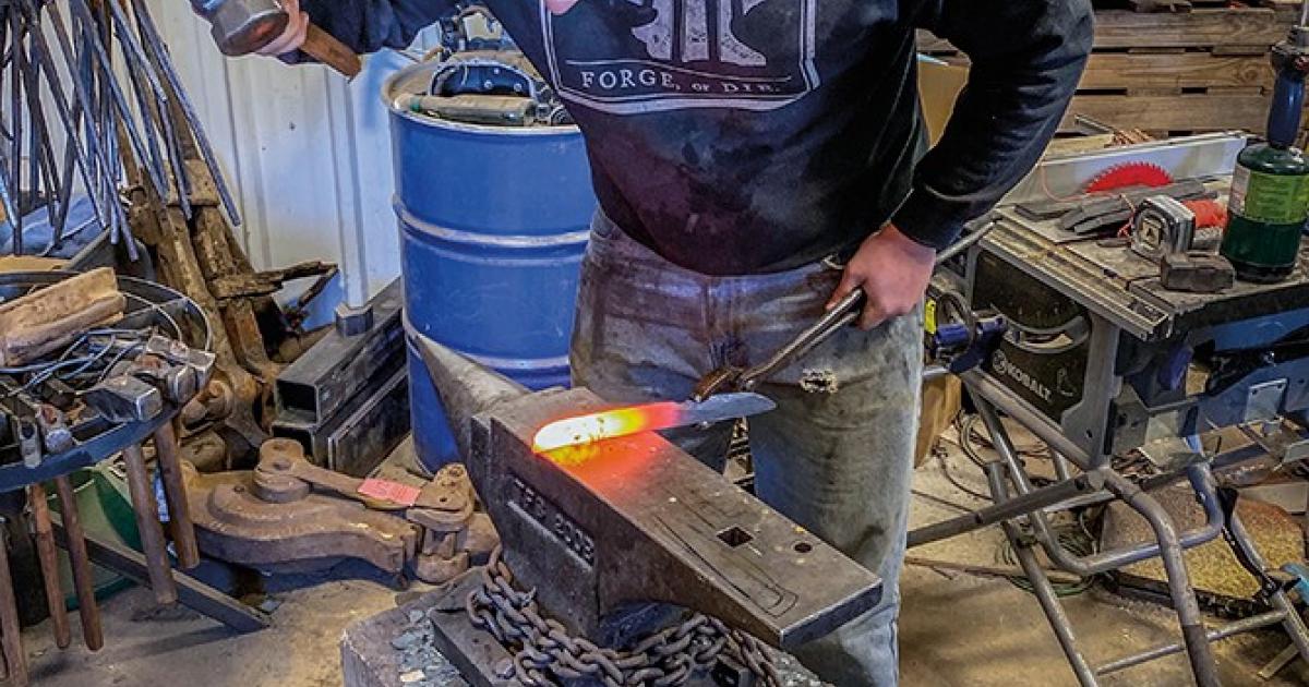 Gabe Jensen hammers the heated steel, shaping it into a knife blade.