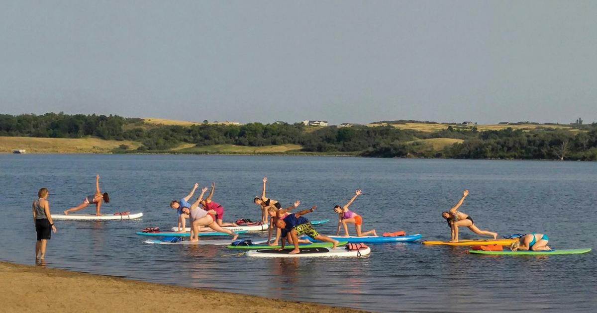 Paddle On hosts instructor-led yoga and fitness classes on the water with paddle boards at Harmon Lake, Mandan.