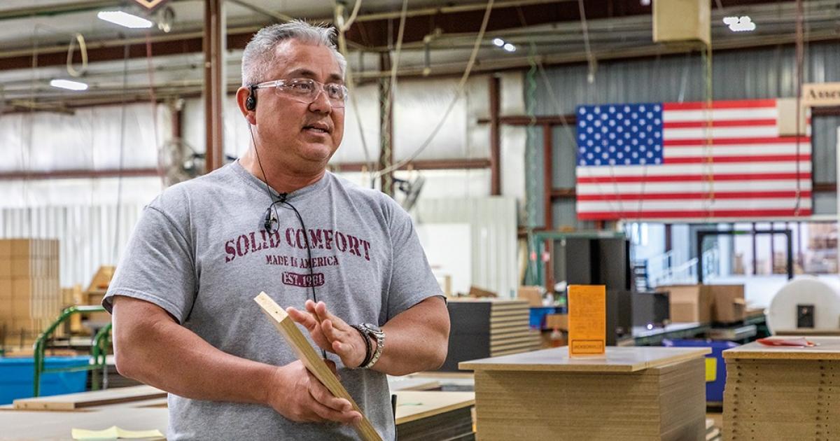 John Tucker explains Solid Comfort's manufacturing process, which generates wood case goods for the hospitality industry. Photo by NDAREC/Liza Kessel