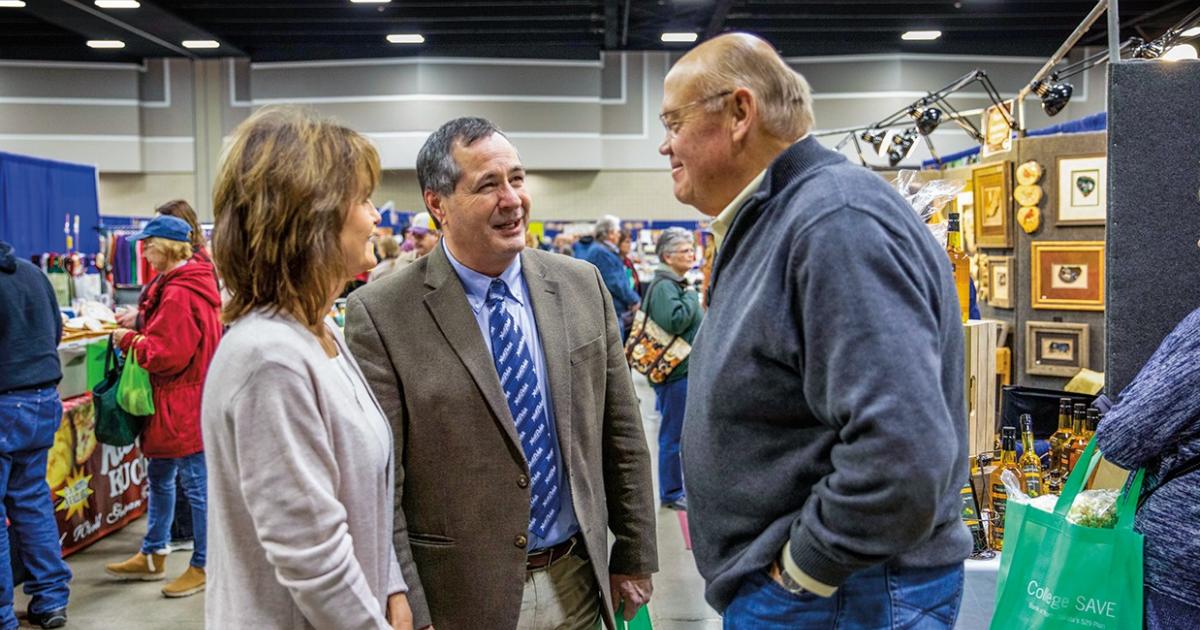 N.D. Agriculture Commissioner Doug Goehring and his wife, Annette, visit with Pride of Dakota retailer Larry White of 17Thistles, which makes cold-pressed safflower cooking oil, at the 2019 Pride of Dakota Holiday Showcase in Bismarck. Photo  Courtesy N.D. Department of AgriculTure
