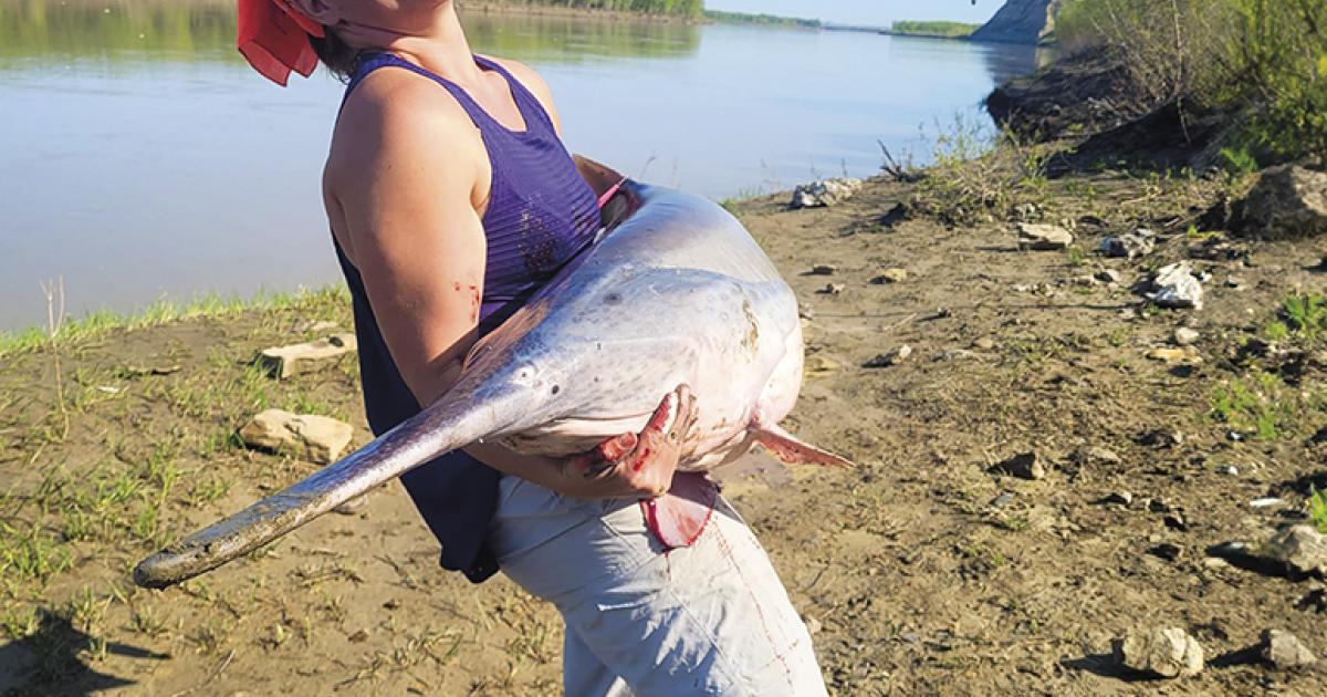 Emma Kleingartner holds her 2023 paddlefish