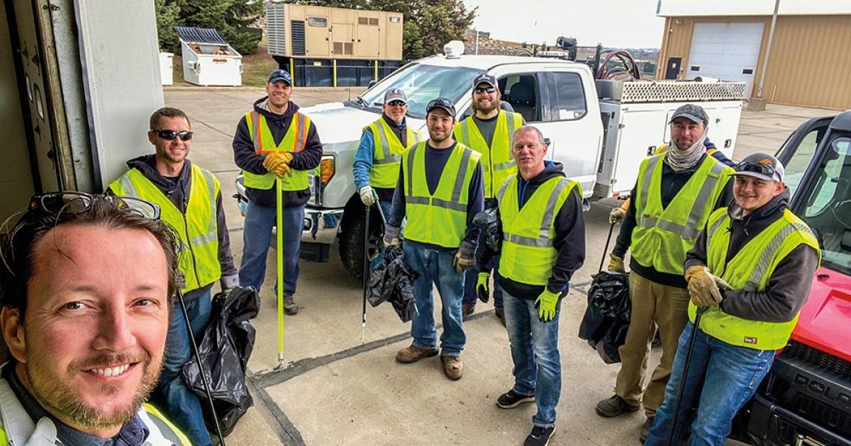 David Straley, front left, joins a group of Capital Electric Cooperative employees in a cleanup effort for a portion of Highway 83 in north Bismarck.