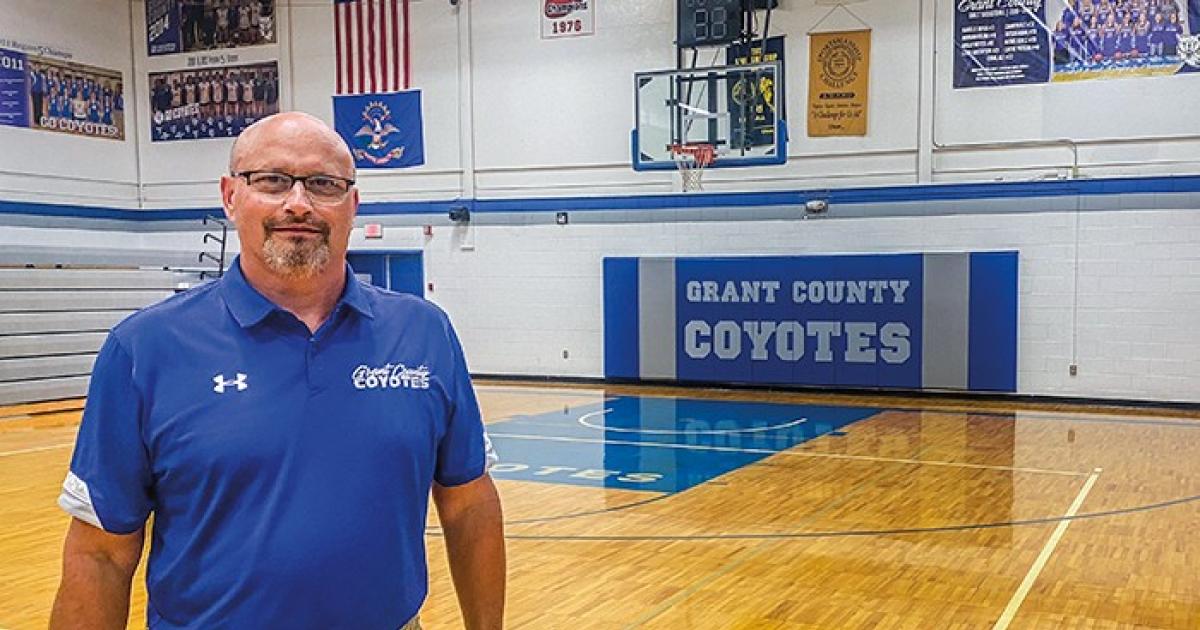 Grant County High School Principal and Athletic Director Terry Bentz stands in the Coyotes gym in Elgin. The Elgin/New Leipzig School District, home of the Grant County High School Coyotes, has walked through both a school district consolidation and several sports co-op agreements through the decades. The district now co-ops with Flasher High School in football, track and golf and has applied to co-op with Mott/Regent in boys basketball starting next season. Photo by Luann Dart