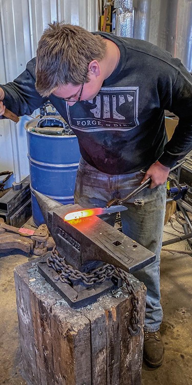 Gabe Jensen hammers the heated steel, shaping it into a knife blade.